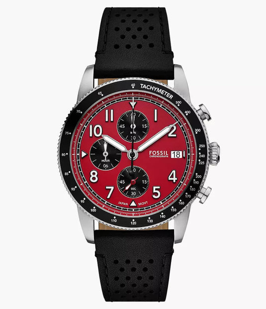 Fossil wristwatch with a red dial, black bezel, silver-tone case, and perforated black strap, centered on a light gray background.