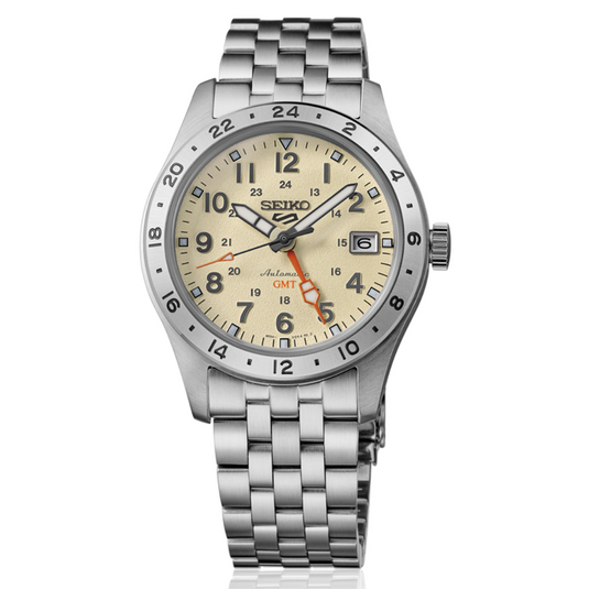 A Seiko wristwatch with a stainless steel link bracelet, featuring a cream-colored dial with black Arabic numerals, a rotating black bezel, and orange accent hands.