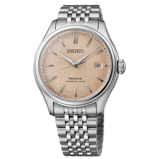 A Seiko Presage automatic watch with a silver stainless steel case and link bracelet, featuring a textured champagne-gold dial with silver baton indices and a date window at 3 o'clock.