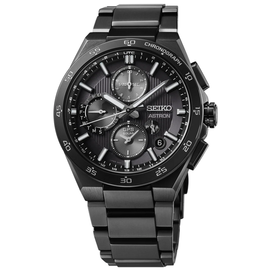 A Seiko Astron chronograph watch with a matte black stainless steel case and integrated link bracelet, featuring a textured black dial with silver-tone indices and subdials.