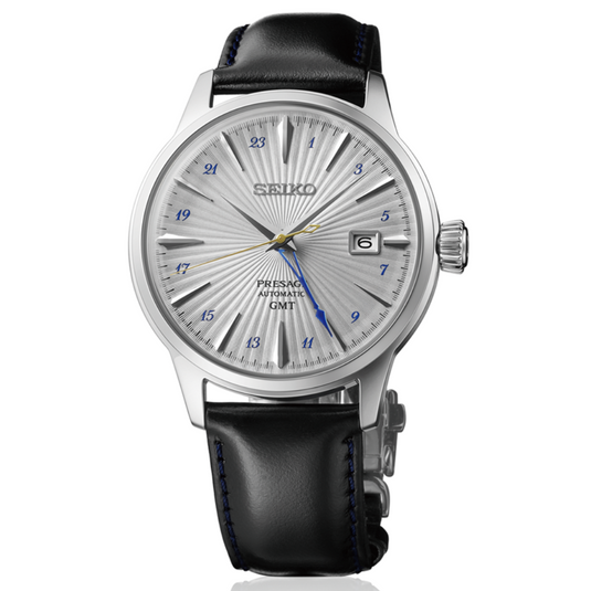 A Seiko wristwatch with a silver sunburst dial, silver-tone case, and a black leather strap with blue stitching, shown on a clean white background.
